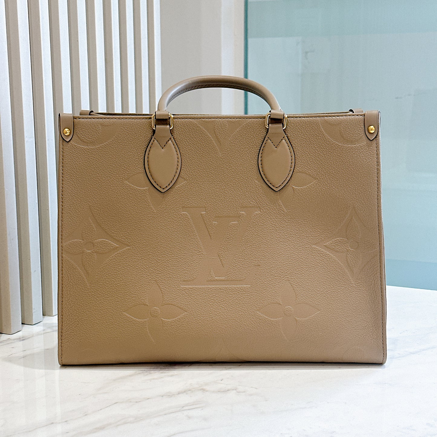 LV On The GO MM in Tourterelle Empreinte Leather