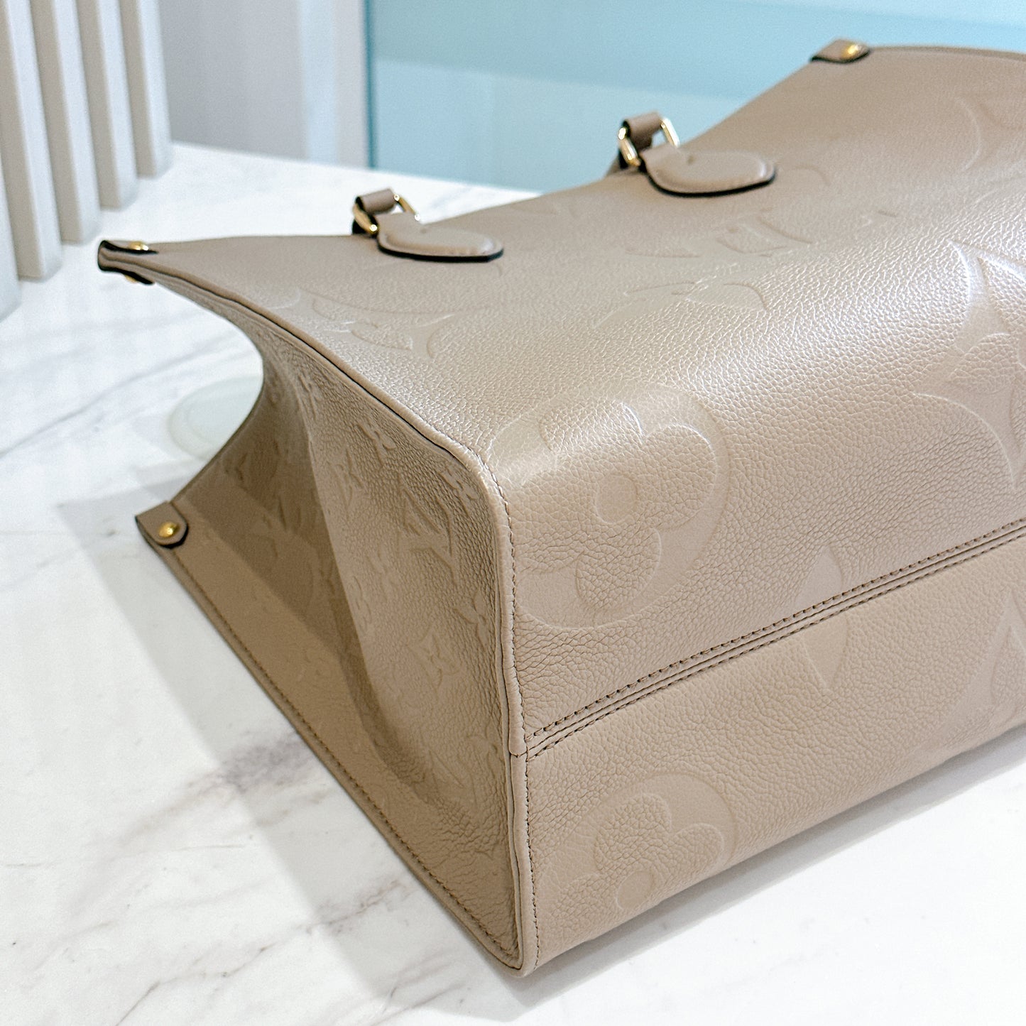 LV On The GO MM in Tourterelle Empreinte Leather