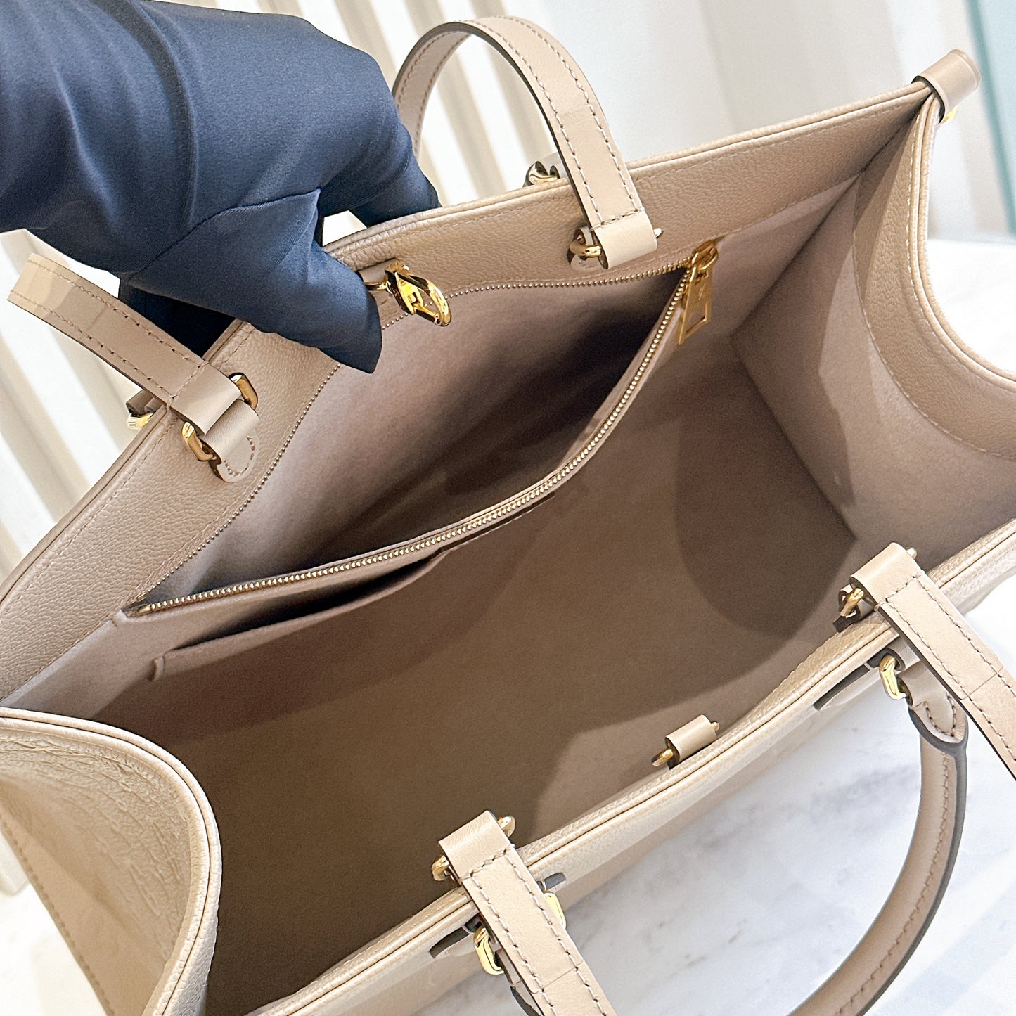 LV On The GO MM in Tourterelle Empreinte Leather