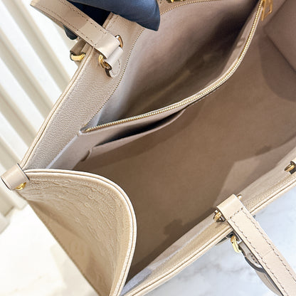 LV On The GO MM in Tourterelle Empreinte Leather