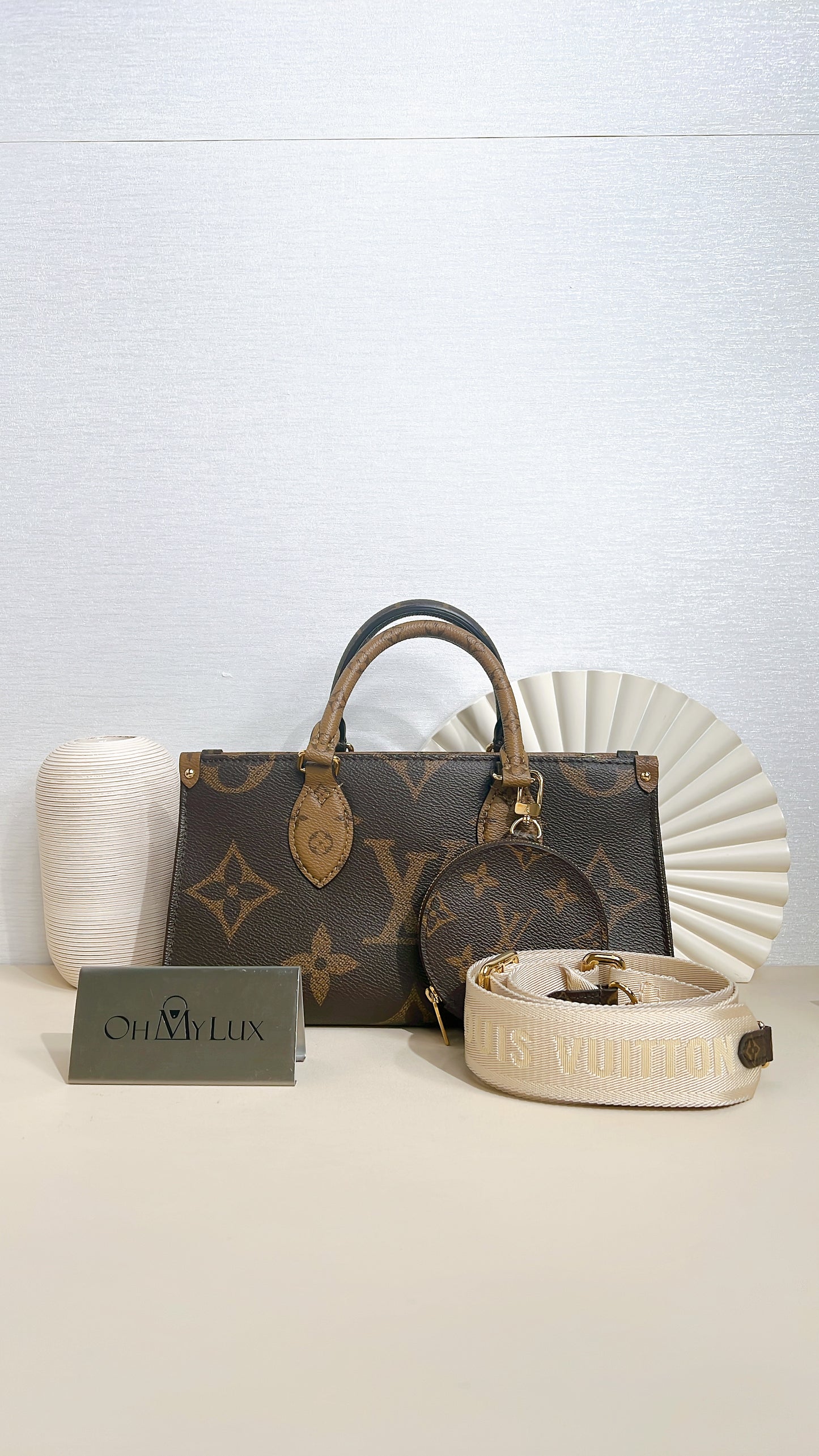 LV On The Go East West in Monogram Reverse
