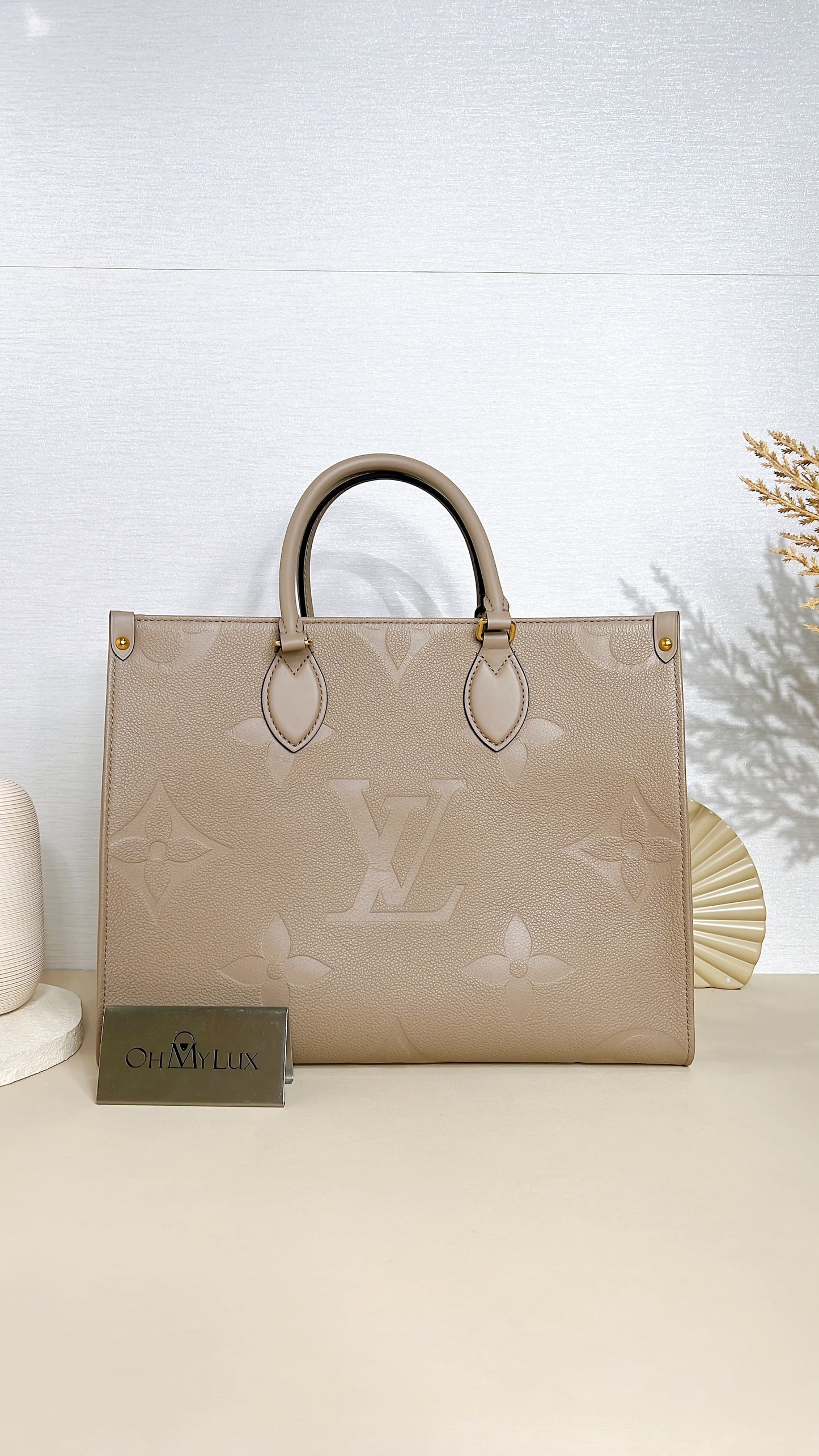 LV On The GO MM in Tourterelle Empreinte Leather