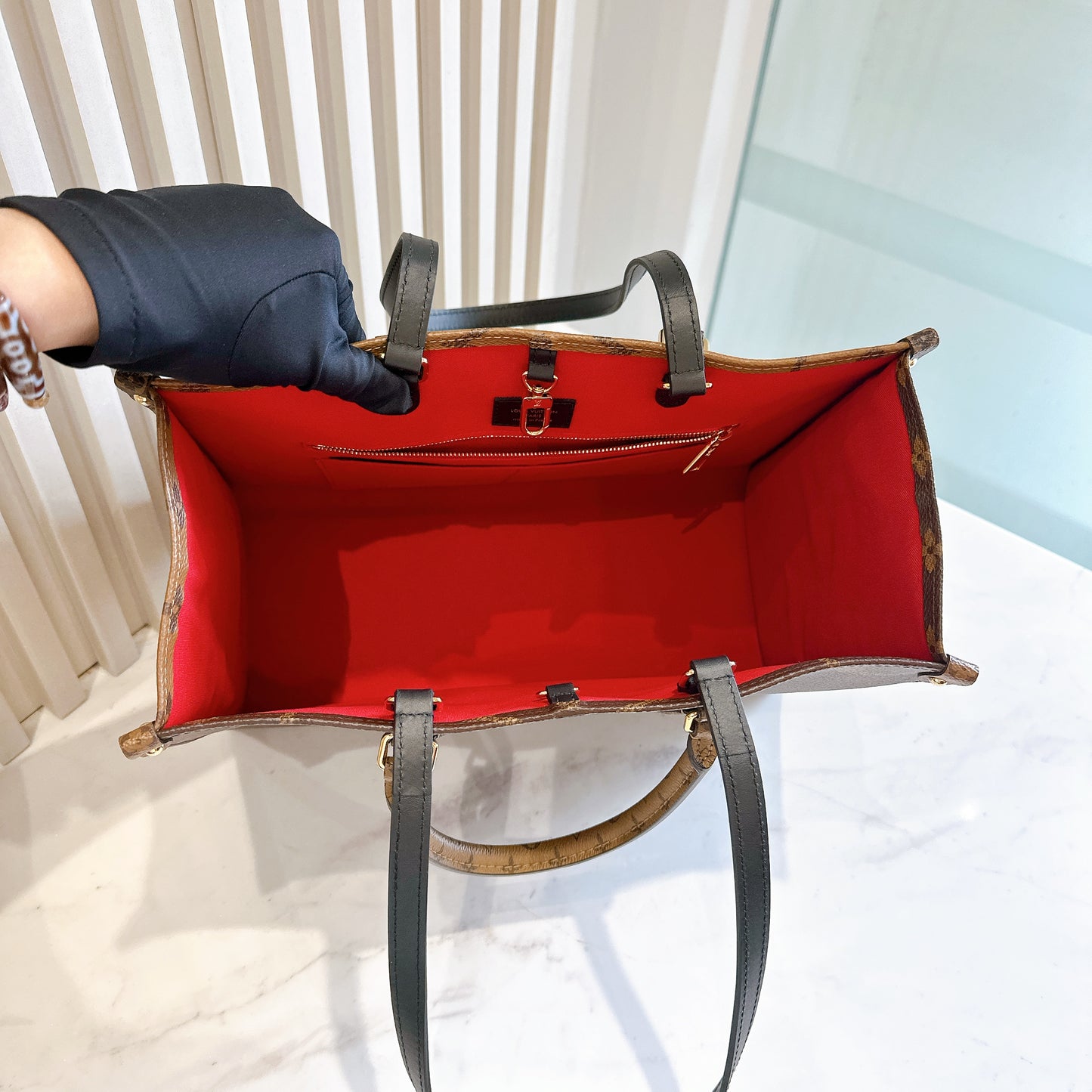 LV On The Go MM in Reverse Monogram