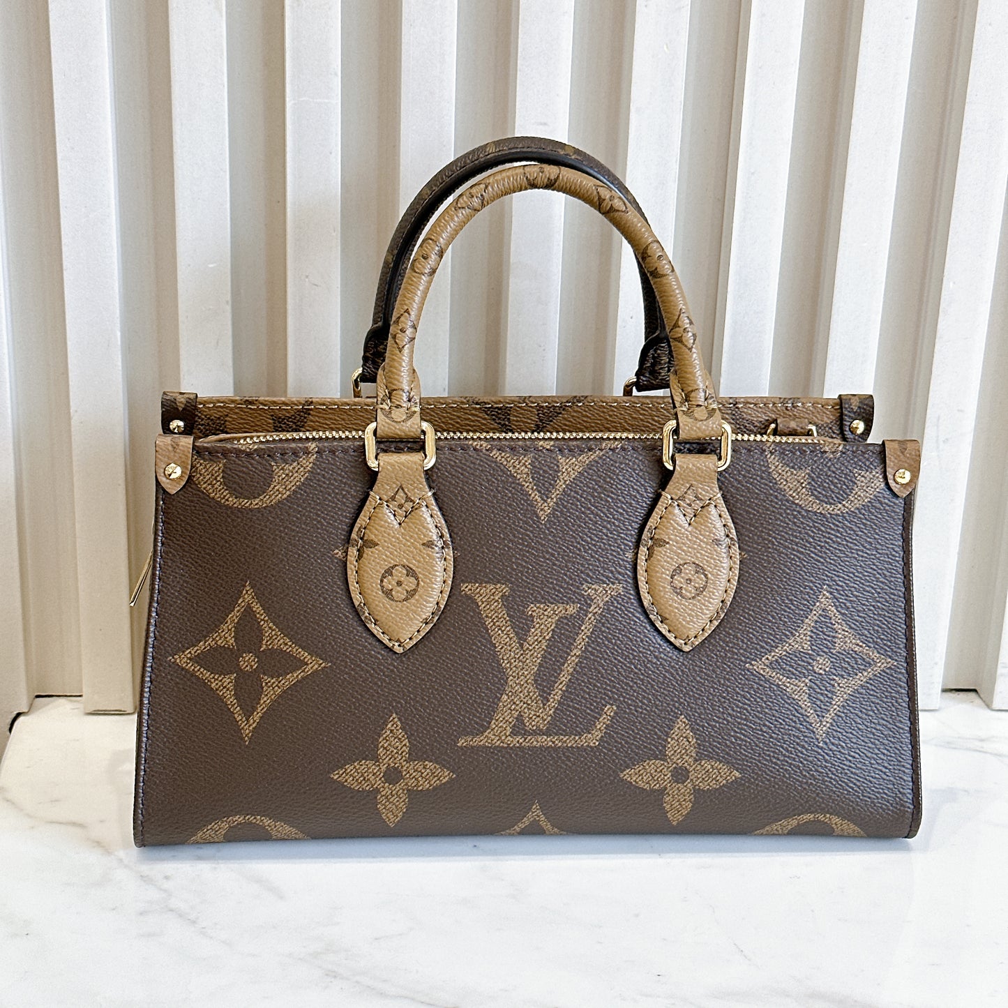 LV On The Go East West Reverse Monogram
