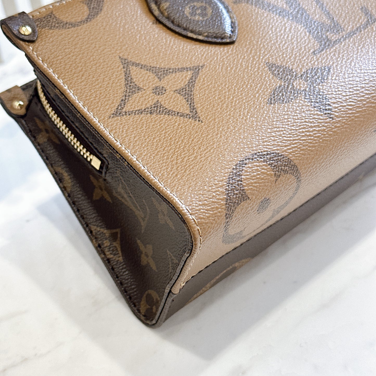 LV On The Go East West Reverse Monogram