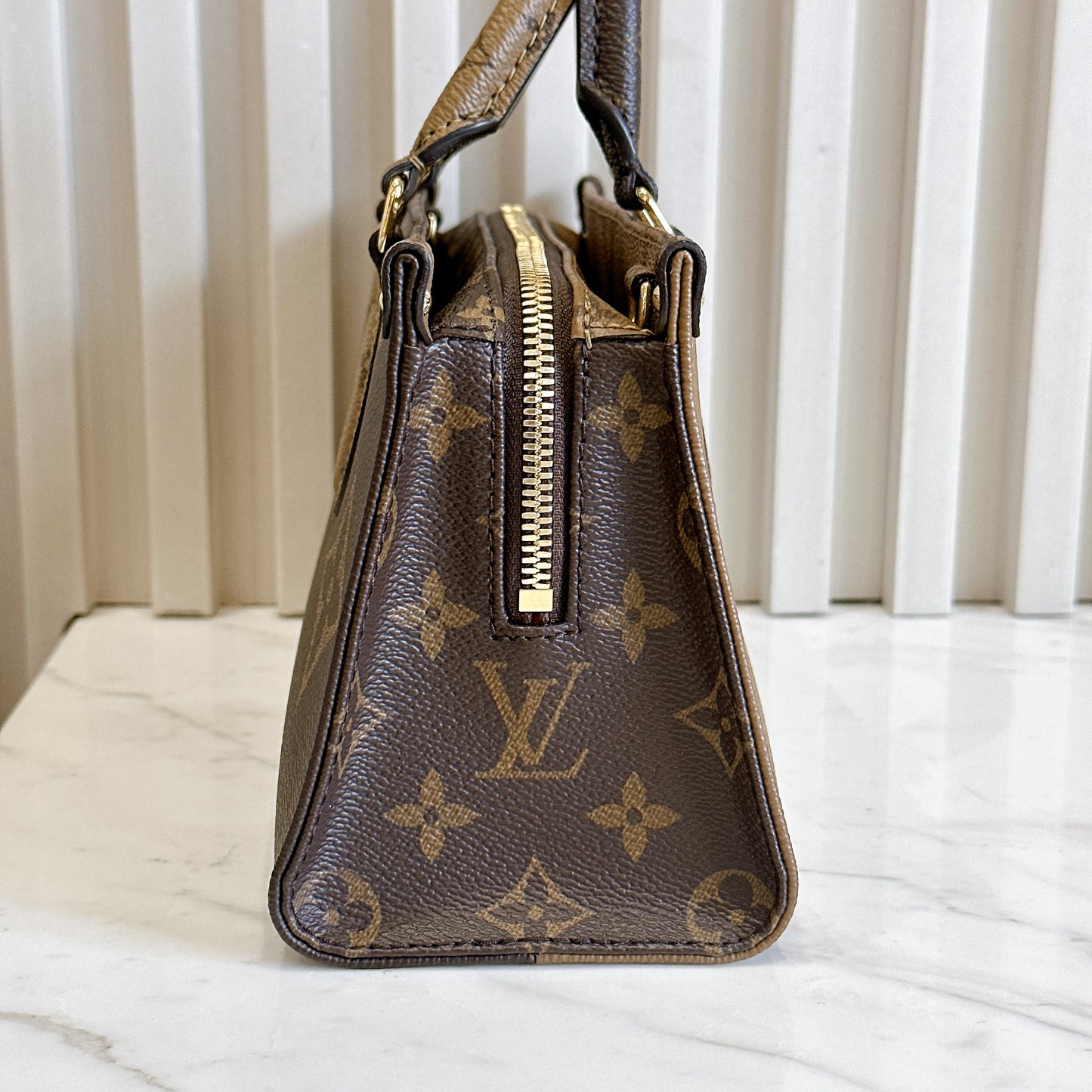 LV On The Go East West Reverse Monogram