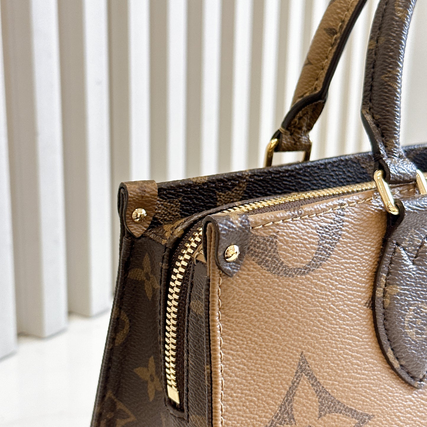 LV On The Go East West Reverse Monogram