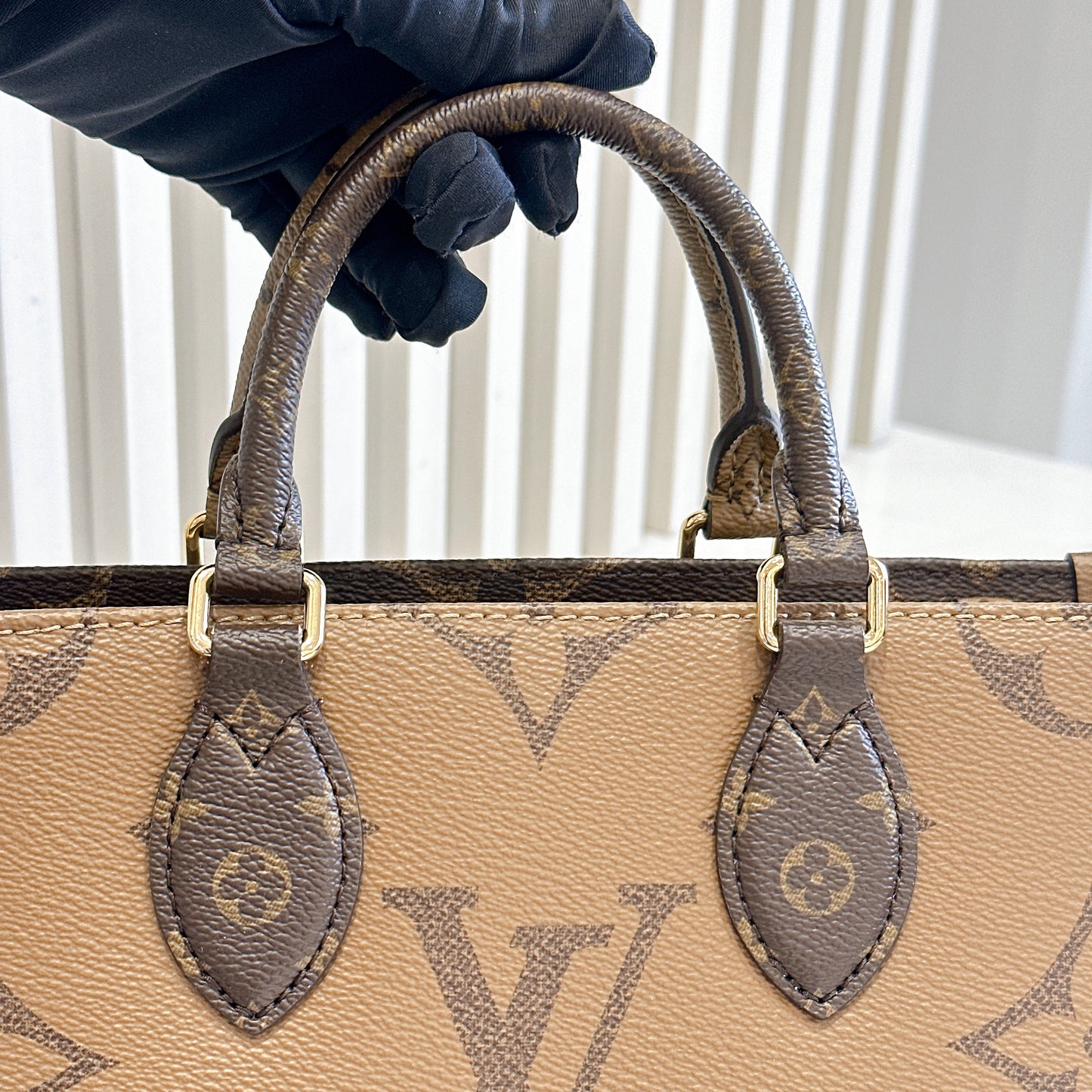 LV On The Go East West Reverse Monogram