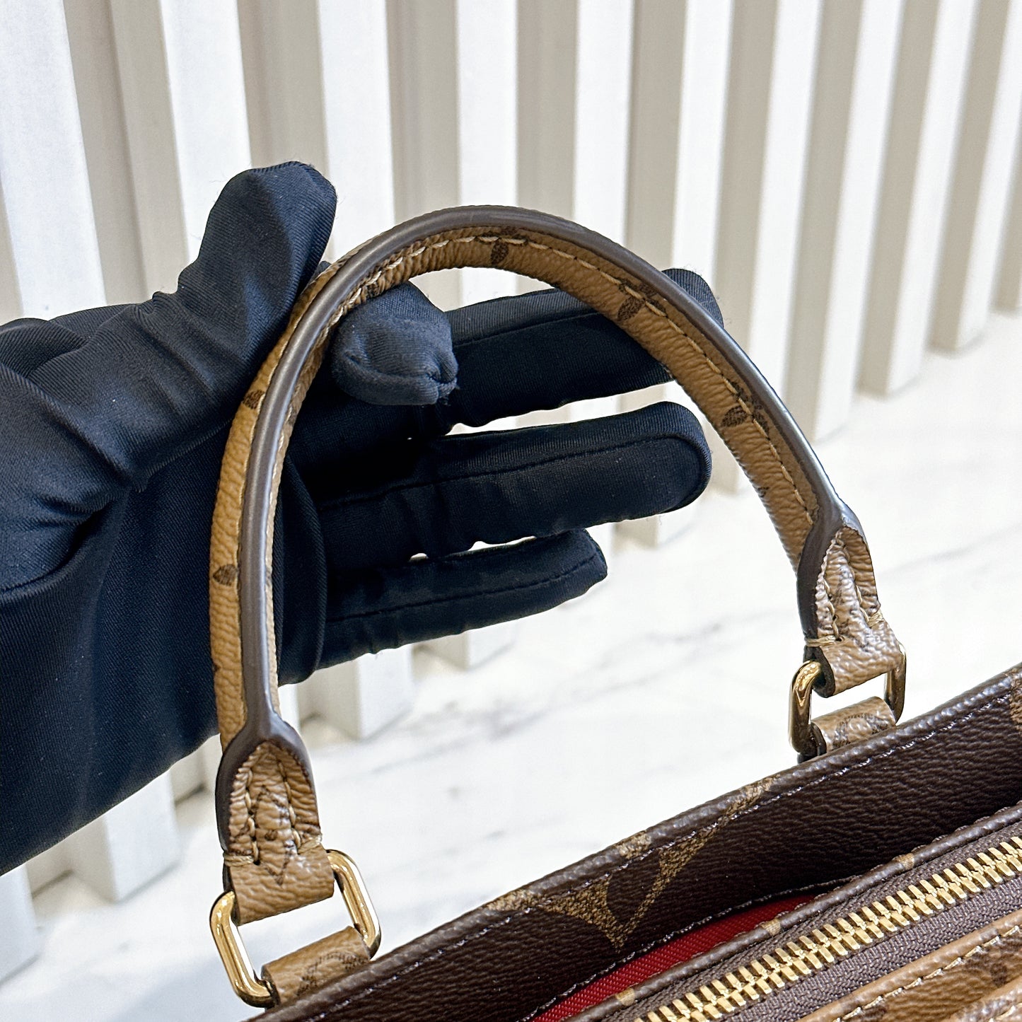LV On The Go East West Reverse Monogram