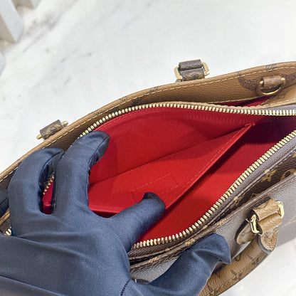 LV On The Go East West Reverse Monogram