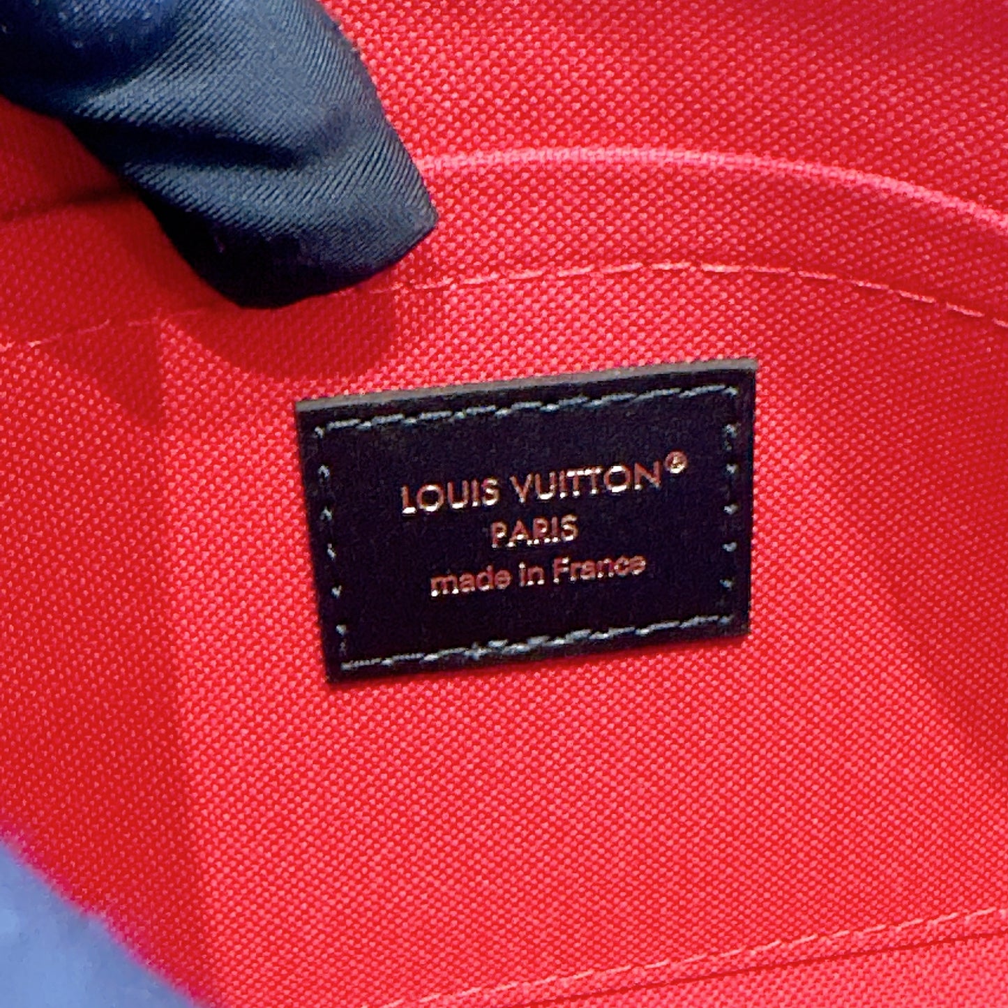 LV On The Go East West Reverse Monogram