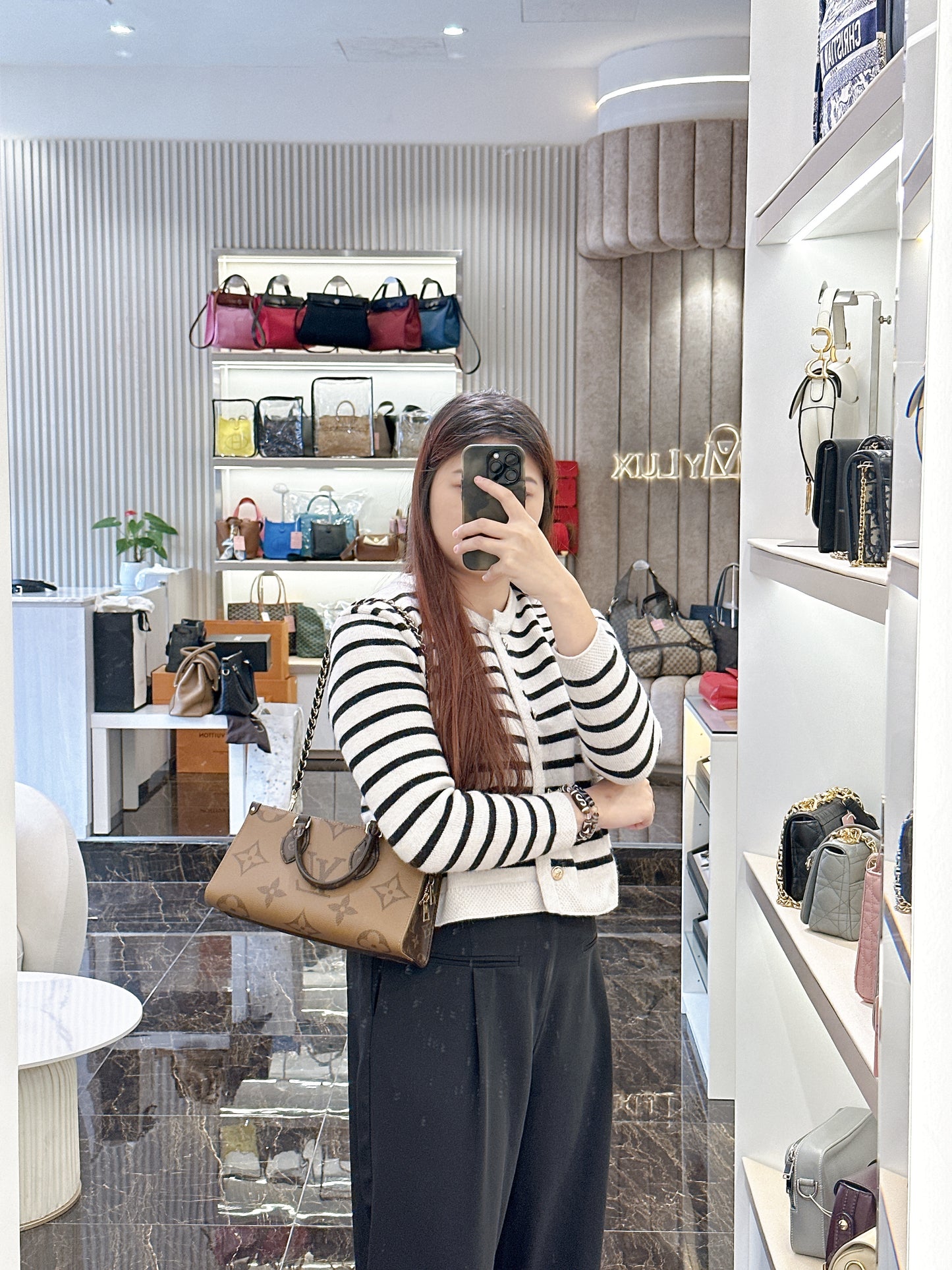 LV On The Go East West Reverse Monogram