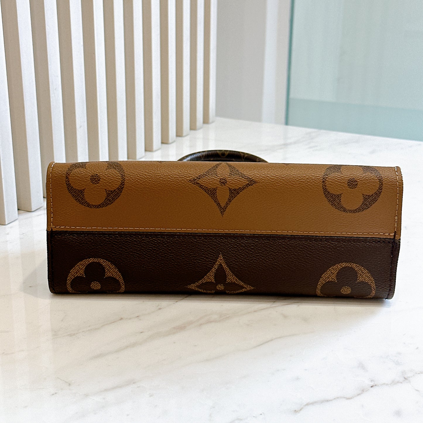 LV On The Go East West in Monogram Reverse