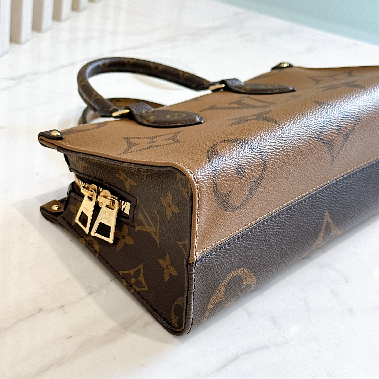LV On The Go East West in Monogram Reverse