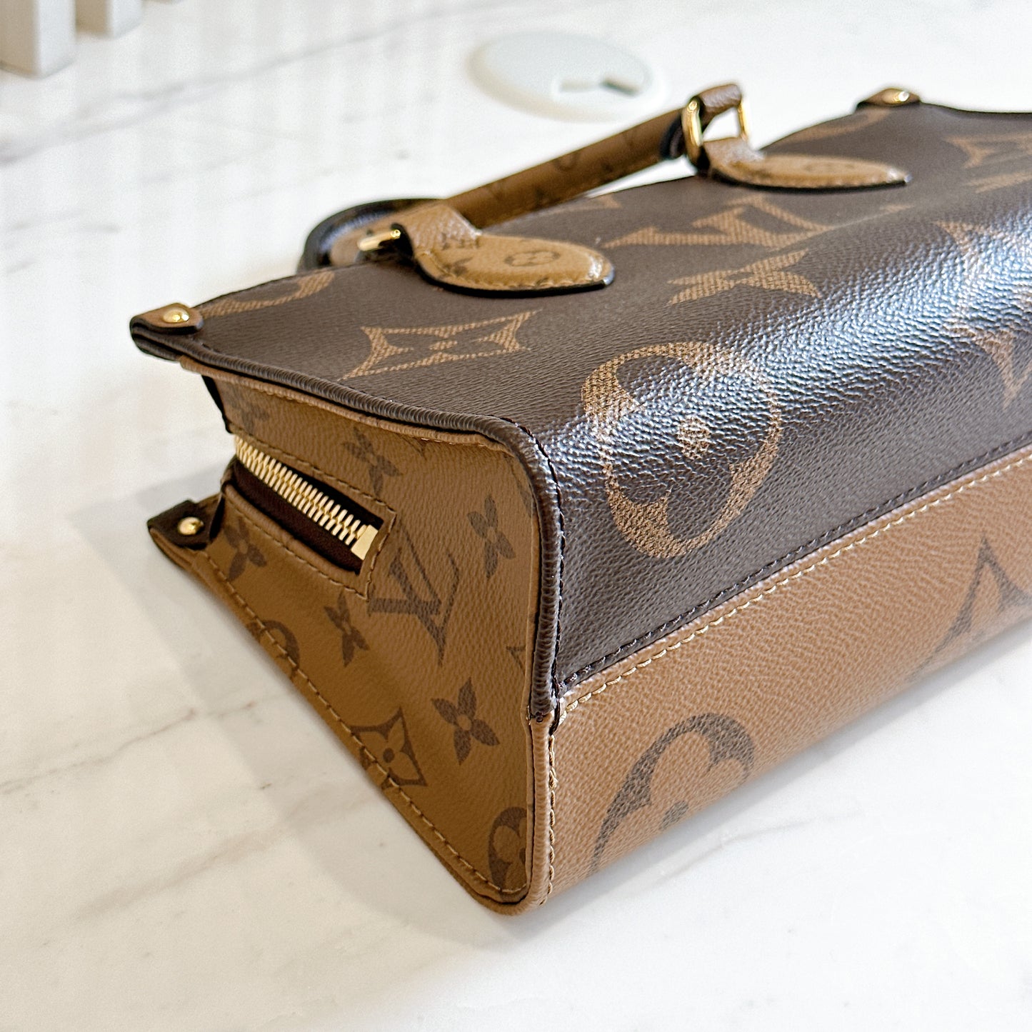 LV On The Go East West in Monogram Reverse