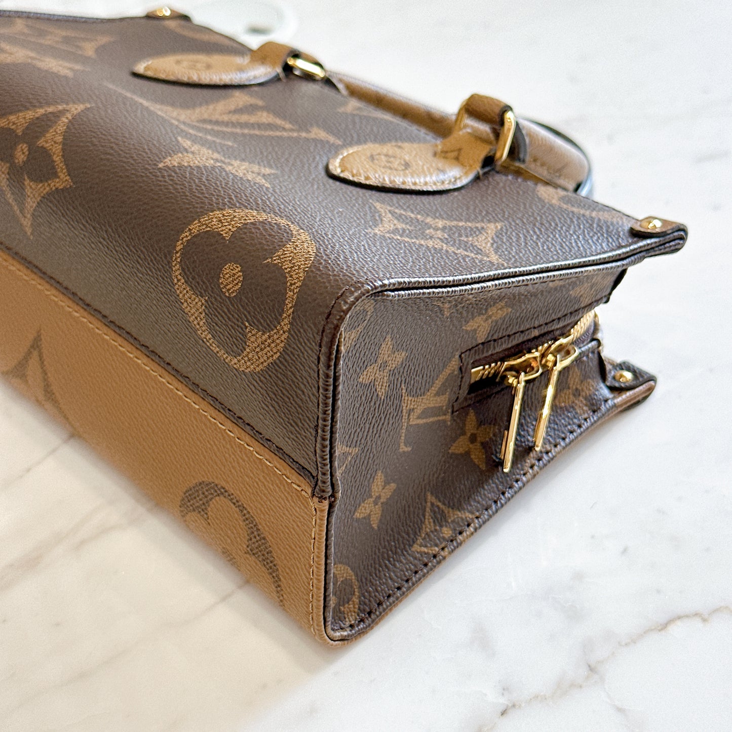 LV On The Go East West in Monogram Reverse