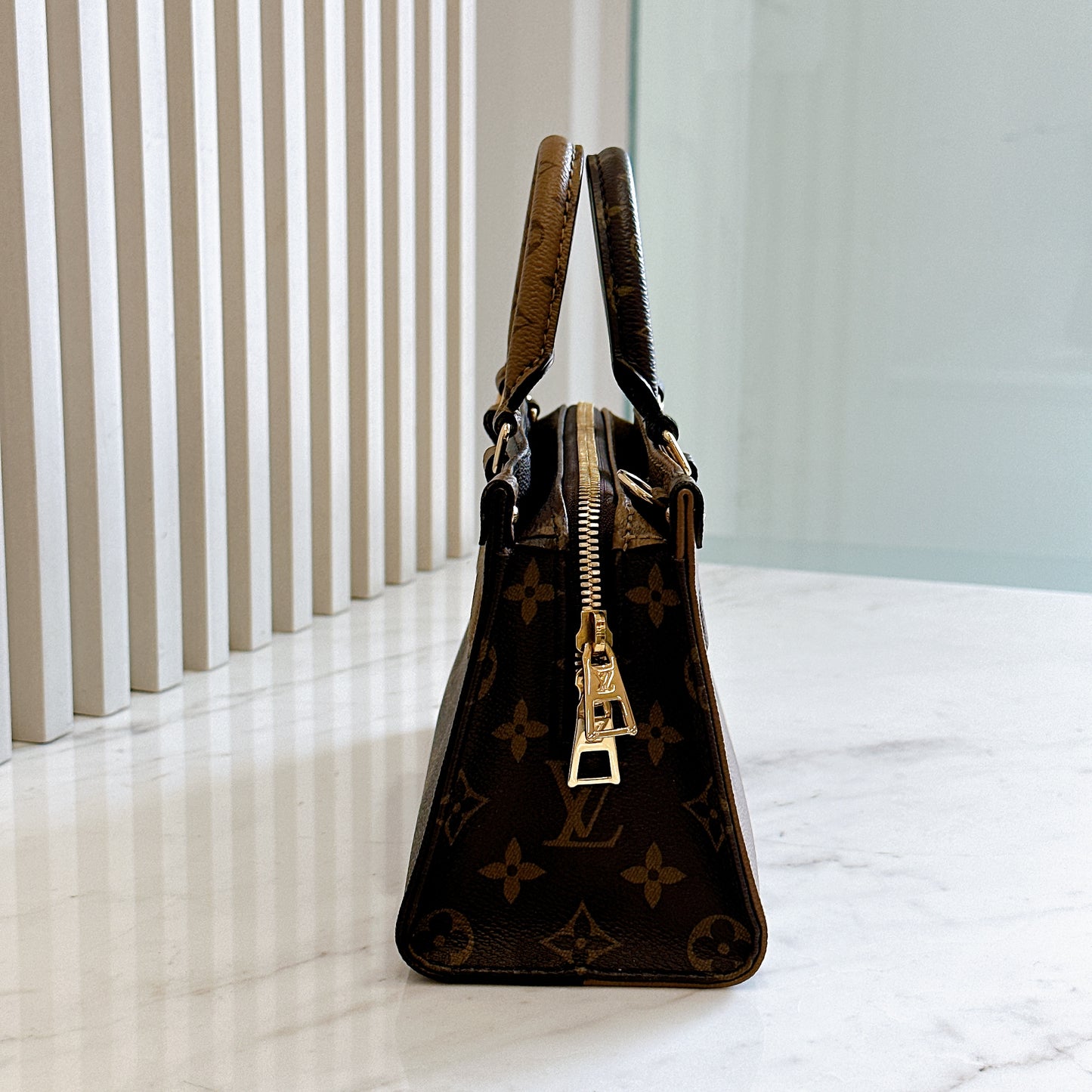 LV On The Go East West in Monogram Reverse