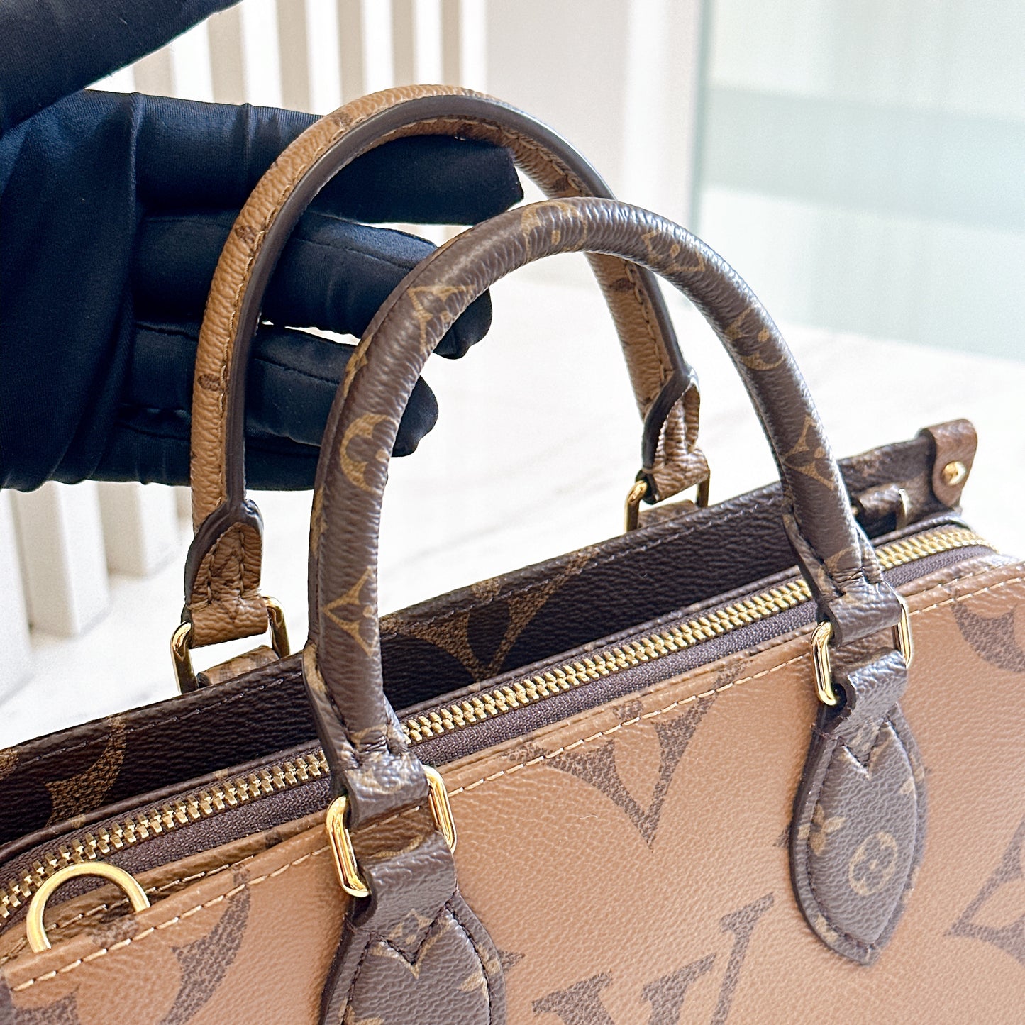 LV On The Go East West in Monogram Reverse