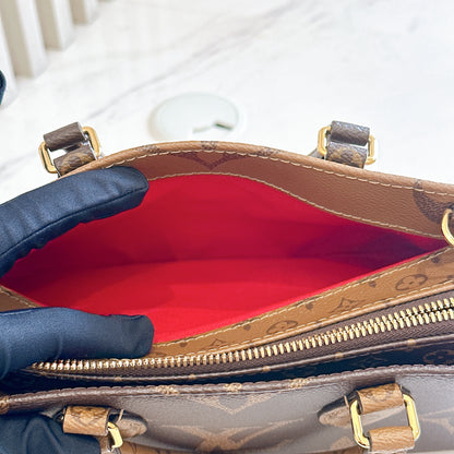 LV On The Go East West in Monogram Reverse