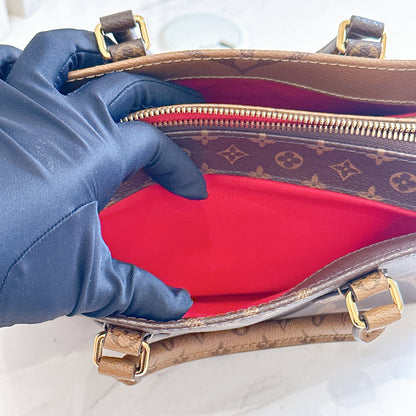 LV On The Go East West in Monogram Reverse