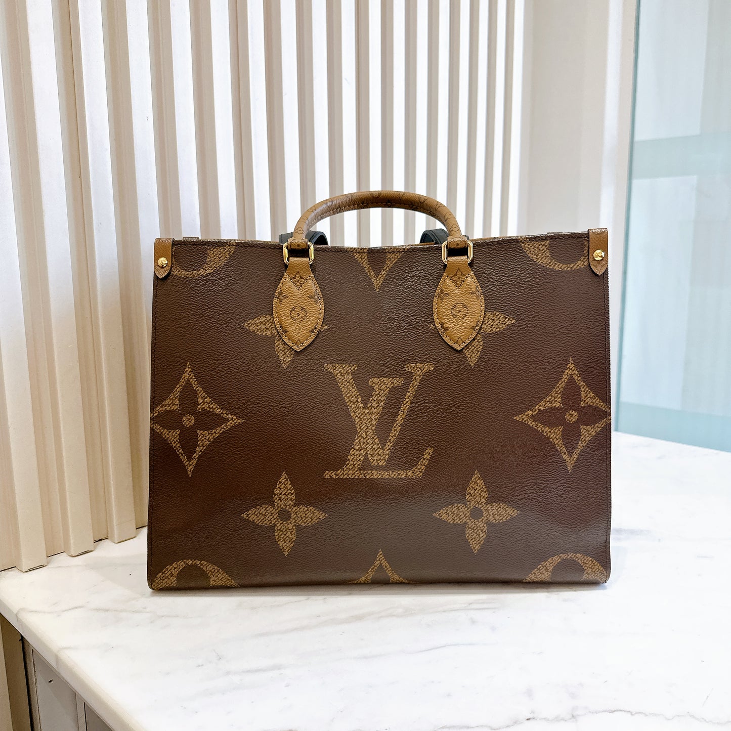 LV On The Go MM in Reverse Monogram